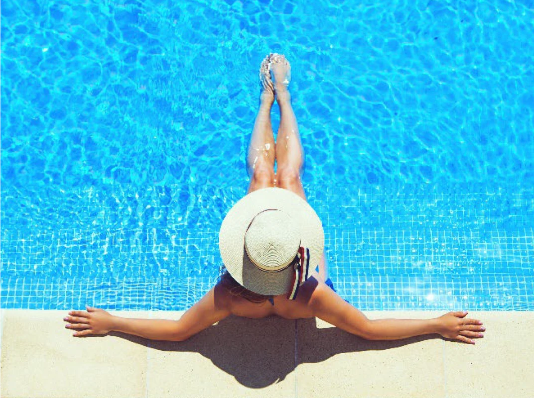Woman sitting in swimming pool at Halstead Chantilly